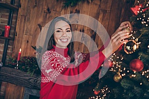 Photo of cute attractive young lady wear red pullover smiling decorating christmas tree indoors house home room
