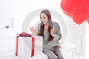 Photo of cute charming lady wear grey pajama enjoy getting birthday surprise indoors house bedroom