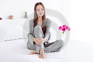 Photo of cute charming lady wear grey pajama enjoy weekend having rest bed indoors house bedroom