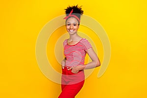 Photo of cute cheerful girl dressed red striped t-shirt smiling hands arms pockets isolated yellow color background