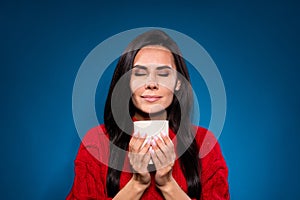 Photo of cute dreamy young woman dressed red pullover enjoying beverage aroma isolated dark blue color background