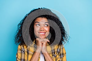 Photo of cute lady hands chin look empty space anticipate dream wear checkered shirt isolated blue color background