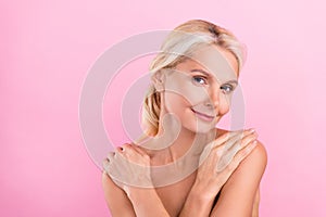 Photo of cute lovely pretty senior woman hugging herself concept love and care  on pink color background