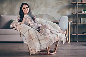 Photo of cute optimistic girl lying hold cup look empty space wear pijama spectacles at home photo