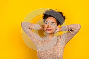 Photo of cute young brunette lady palms head wear beige pullover isolated on yellow color background