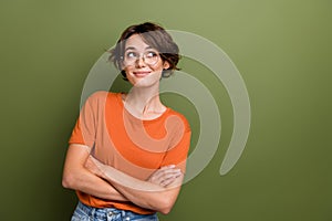 Photo of cute young business lady folded arms looking empty space deciding what to do in her future isolated on khaki