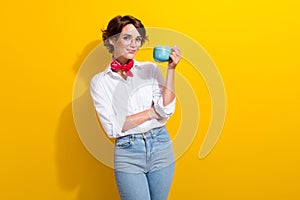 Photo of cute young business lady holding blue cup cappuccino drinking morning breakfast energy isolated on yellow color