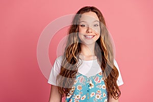 Photo of cute young girl beaming smile empty space wear dress isolated on pink color background