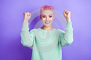 Photo of delighted positive girl toothy smile raise fists luck accomplishment isolated on violet color background