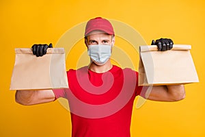 Photo of delivery guy hands hold carton packages wear red t-shirt cap gloves isolated yellow color background