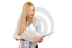 Pretty female blonde student reading books on white isolated background