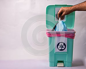 Photo of disposing face masks in a plastic trash bin