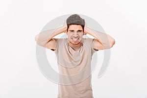 Photo of distressed emotional man 30s grabbing his head or cover