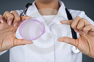 Doctor Holding Diaphragm And Vaginal Ring photo
