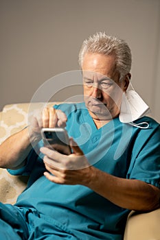 Photo of a doctor or male nurse using a cellular smartphone