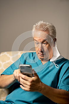 Photo of a doctor shocked while reading a phone text message