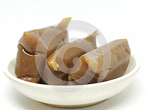Photo of Dodol or jenang or nian gao is traditional snack from Java, Indonesia isolated on white background.