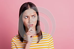 Photo of doubtful envy lady look side empty space finger chin frown distrustful face on pink background