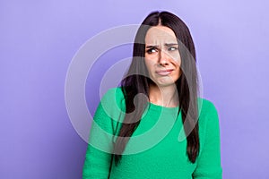 Photo of doubtful unsure lady dressed green sweater looking emtpy space isolated violet color background