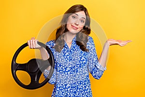 Photo of doubtful unsure lady wear print shirt shrugging shoulders driving auto isolated yellow color background