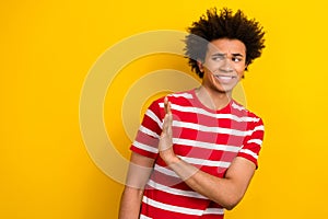 Photo of doubtful unsure man wear striped t-shirt rising arm showing no empty space isolated yellow color background
