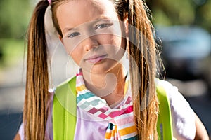 Photo of dreamy charming little girl dressed tied sweater rucksack travelling enjoying sightseeing outdoors urban city