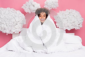 Photo of dreamy cheerful lady wear pajama sitting bed cover blanket feeling cold clouds isolated pink color background