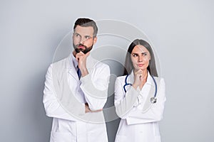 Photo of dreamy clever two docs dressed white coats looking empty space hands arms chins isolated grey color background