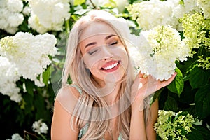 Photo of dreamy cute sweet shiny lovely woman with closed eyes walking botanical garden enjoying nature spring beauty