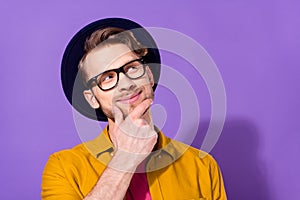 Photo of dreamy young positive cheerful man look empty space minded think isolated on violet color background