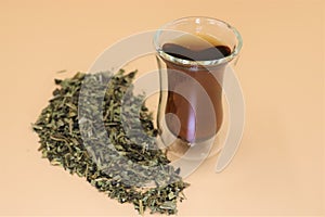 Glass cup of herbal tea with plantain leaves. photo