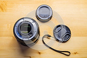 Photo DSLR Camera or Video lens close-up on wooden background, objective, concept of photographer camera man job, looking for a ph