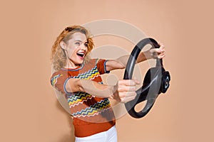 Photo of eccentric woman with foxy hairstyle dressed knit t-shirt hold steering wheel look empty space isolated on