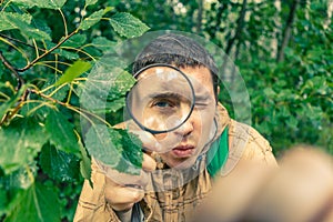 Photo of ecologist man with magnifying glass