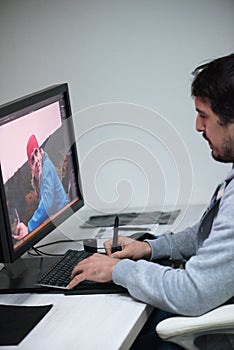 Photo editor at his desk