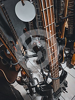 Photo of an electric bass with other musical instruments in the background