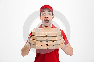 Photo of emotional guy from delivery service in red t-shirt and photo