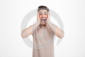 Photo of emotional unshaved guy with exciting facial expressions