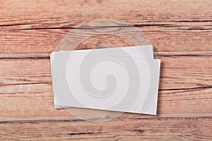 Photo of empty business cards on a light natural wooden background .. Template for identifier