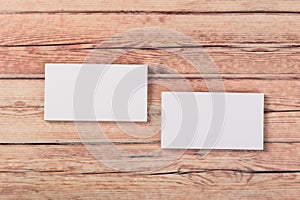 Photo of empty business cards on a light natural wooden background .. Template for identifier