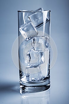 Photo of empty glass with ice cubes on studio shot