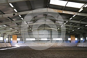 Photo of an empty indoor riding hall for horses and riders