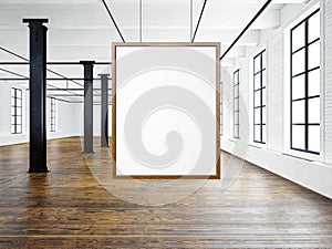 Photo of empty interior in modern loft. Open space loft.Empty white canvas hanging on the wood frame. Wood floor, bricks