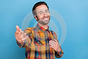 Photo of excited friendly young man wear plaid shirt arm chest inviting you smiling isolated blue color background