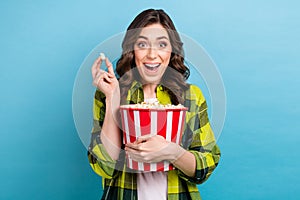 Photo of excited funky woman dressed plaid shirt watching film eating pop corn isolated blue color background