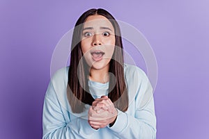 Photo of excited glad lady hold hands anticipate lucky bet win wear blue shirt isolated on violet background