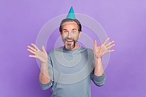 Photo of excited mature man good mood unexpected event headwear isolated over violet color background