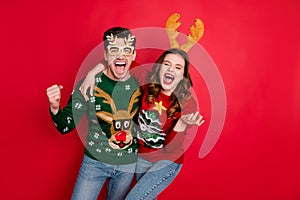 Photo of excited pair lady and guy chilling at newyear theme costume party wear funky knitted pullovers with ornaments