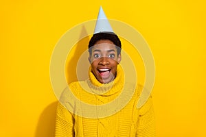 Photo of excited surprised cheerful trans male celebrate birthday holiday vacation isolated on yellow color background