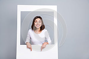 Photo of excited sweet young woman wear white outfit pointing fingers empty space smiling isolated grey color background